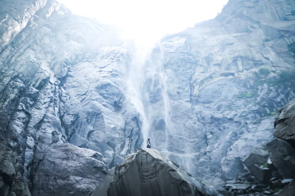 A man standing between ice mountains
