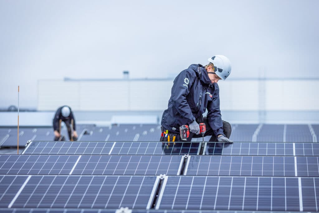 Young man assembling solar panel