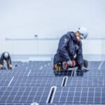 Young man assembling solar panel